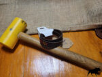 Brown leather bracelet with cross stitched design