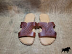 Hand made leather sandals with feathers tooled on the tops