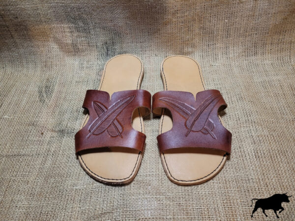 Hand made leather sandals with feathers tooled on the tops