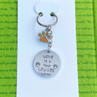 ‘love is a four legged word’ hand stamped keychain
