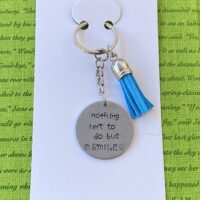 ‘nothing left to do but smile’ hand stamped keychain