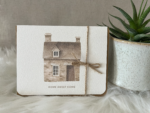 New home greeting card displaying a watercolour stone house