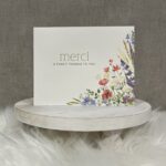 Thank you "Merci" greeting card with a beautiful floral corner