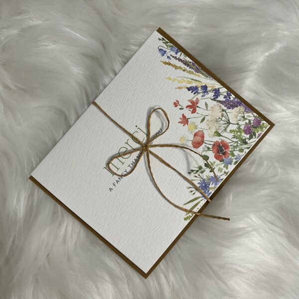 Thank you "Merci" greeting card with a beautiful floral corner