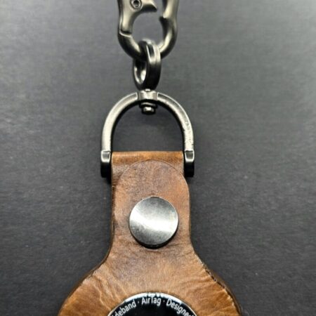 Brown leather apple air tag case on a lobster clasp keychain.