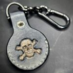 Charcoal Gray Leather Apple Air Tag Case with skull and crossbones on a Lobster Clasp Keychain by JnRcreativeCrafts