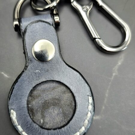 Gray leather Apple AirTag case