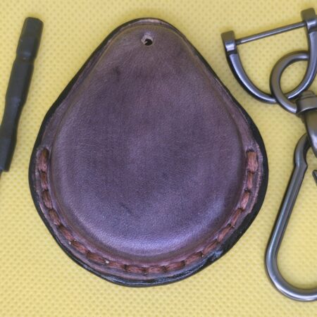 Back view of a mahogany leather key fob case for Harley Davidson motorcycles with stainless steel keychain and screwdriver.