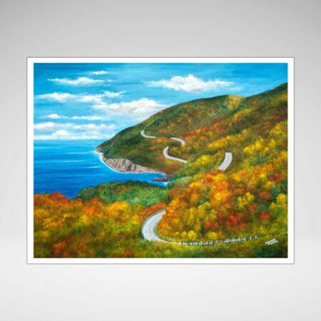 A large mountainous land mass of colorful fall folliage and winding roads. The blue ocean is to the left.