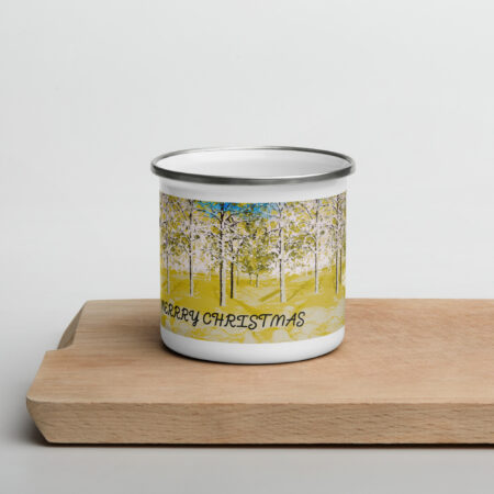 Enamel mug with a forest design and 'Merry Christmas' text on a wooden surface.