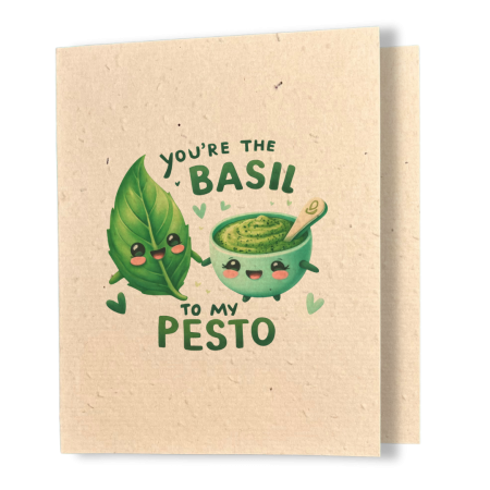 plantable greeting card, natural coloured paper, embedded with wildflower seeds, an image in kawaii style of a basil leaf and a bowl of pesto holding hands, the sentiment reads you're the basil to my pesto
