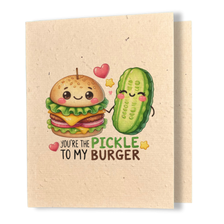 plantable greeting card, natural coloured paper, embedded with wildflower seeds, an image in kawaii style of a burger and a pickle holding hands, the sentiment reads, you're the pickle to my burger