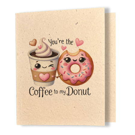 plantable greeting card, natural coloured paper, embedded with wildflower seeds, an image in kawaii style of a cup of coffee and a donut holding hands, the sentiment reads, you're the coffee to my donut