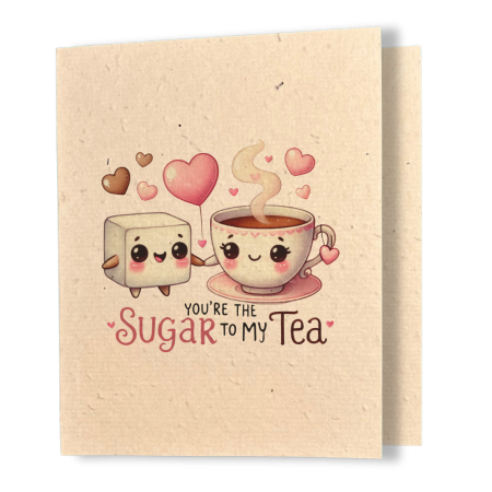 plantable greeting card, natural coloured paper, embedded with wildflower seeds, an image in kawaii style of a cube of sugar and a hot cup of tea holding hands, the sentiment reads, you're the sugar to my tea