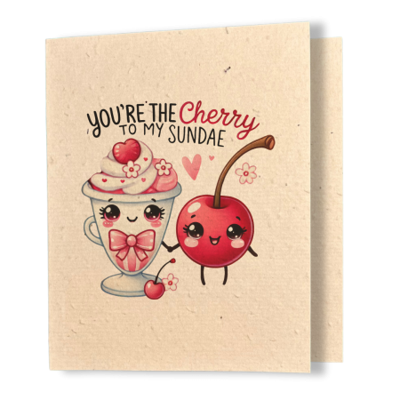 plantable greeting card, natural coloured paper, embedded with wildflower seeds, an image in kawaii style of a sundae and a cherry holding hands, the sentiment reads, you're the cherry to my sundae