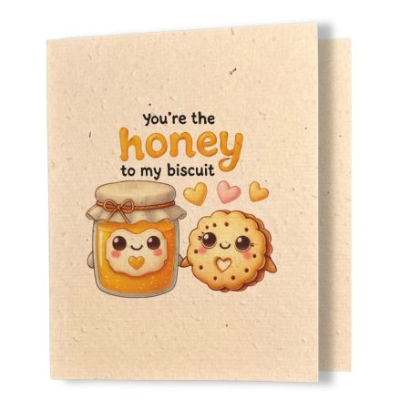 plantable greeting card, natural coloured paper, embedded with wildflower seeds, an image in kawaii style of a homemade jar of honey and a biscuit holding hands, the sentiment reads, you're the honey to my biscuit
