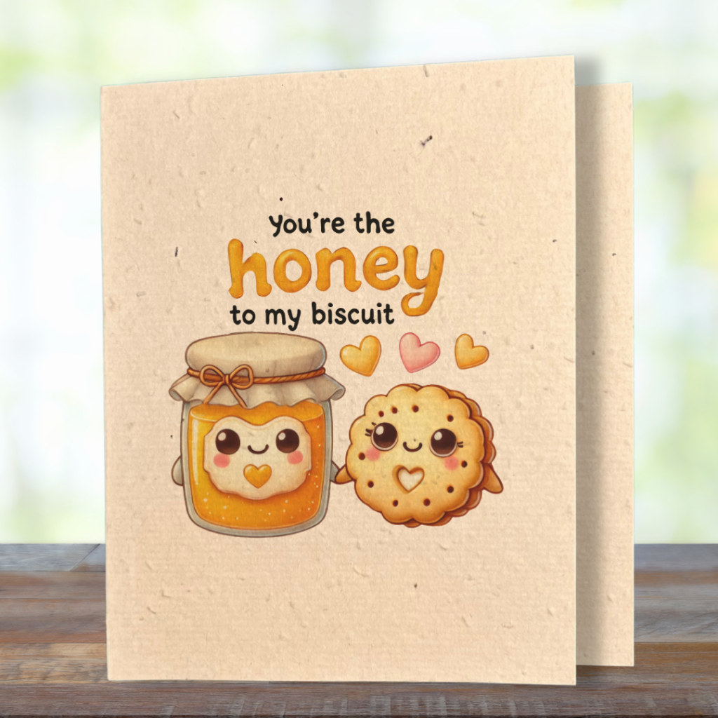 plantable greeting card, natural coloured paper, embedded with wildflower seeds, an image in kawaii style of a homemade jar of honey and a biscuit holding hands, the sentiment reads, you're the honey to my biscuit