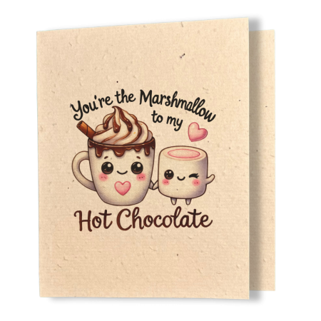 plantable greeting card, natural coloured paper, embedded with wildflower seeds, an image in kawaii style of a cup of hot chocolate with whipped cream and a marshmallow holding hands, the sentiment reads, you're the marshmallow to my hot chocolate