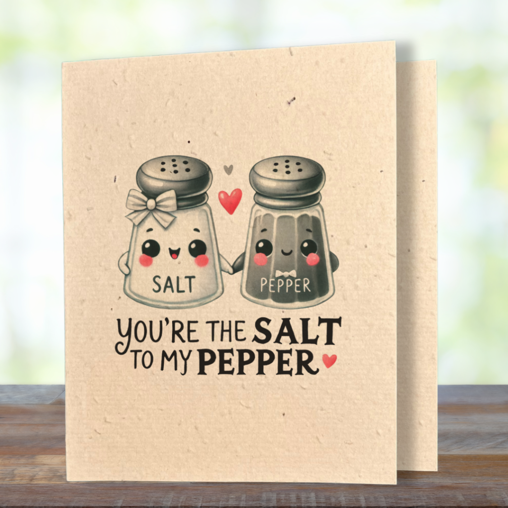 plantable greeting card, natural coloured paper, embedded with wildflower seeds, an image in kawaii style of a salt and pepper shaker holding hands, the sentiment reads, you're the salt to my pepper