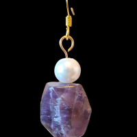 close up of amethyst and pearl earring