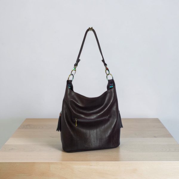 A Slouchy multi pockets eggplant color bag with iridescent hardware and decorative zipper tassels