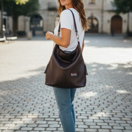 A Slouchy multi pockets eggplant color bag with iridescent hardware and decorative zipper tassels