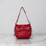 Red floral print slouch bag, matte black hardware.