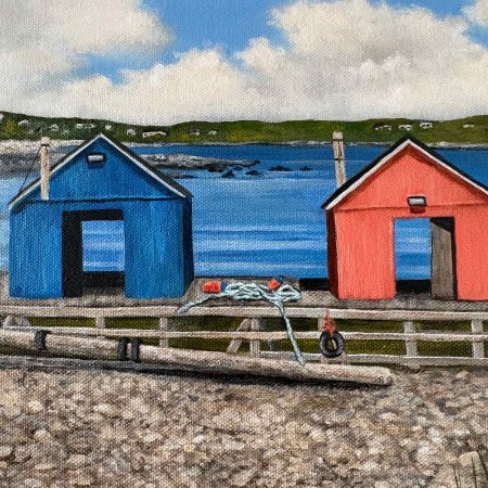 a close up of a blue and orange lobster car sitting on the shore at low tide