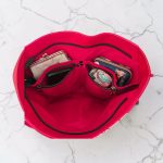 Red floral print slouch bag, matte black hardware.