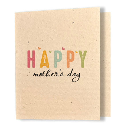 A greeting card printed on textured kraft coloured seed paper. The card features the word "HAPPY" in large, distressed block letters, each letter in a different colour — pink, golden yellow, teal, orange, and green — with small heart accents scattered above them. Below in flowing black script reads "mother's day."