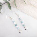 Dangle earrings with white howlite beads, larimar rondelles, sterling silver spacer beads and heart charms, finished on sterling silver hooks.
