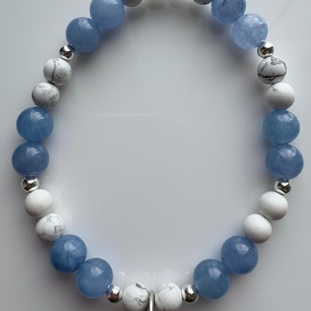 Stretch bracelet of aquamarine and white howlite beads with sterling silver spacer beads and a matte silver disc centerpiece.