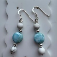 Dangle earrings with white howlite beads, larimar rondelles, sterling silver spacer beads, and sterling silver hooks.