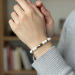 Stretch bracelet of white magnesite beads with mixed-size Navajo pearls and a central Navajo pearl centerpiece.