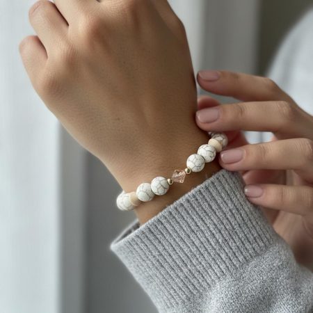 Stretch bracelet of white turquoise and peach quartz beads with cream wood bicones, a central peach Swarovski crystal, and 14K gold-filled spacer beads.