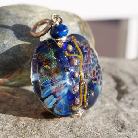 Handmade blue magic pendant with copper wire details and a fantasy glass design